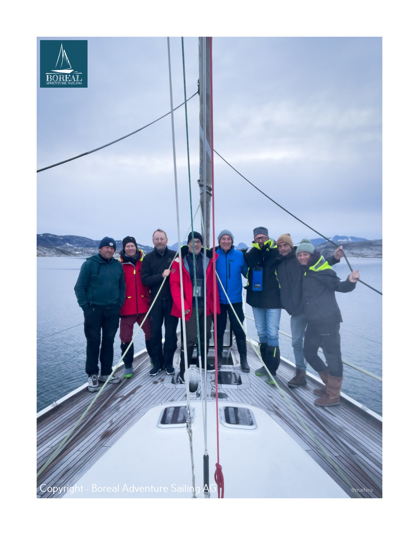 Offshore Sailing: crew together on the foredeck with a fjord behind