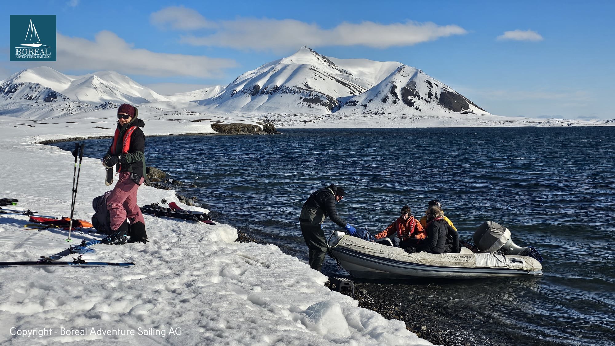 Ski & Sail, Svalbard: ski group landing from the dinghy on a snowy shore
