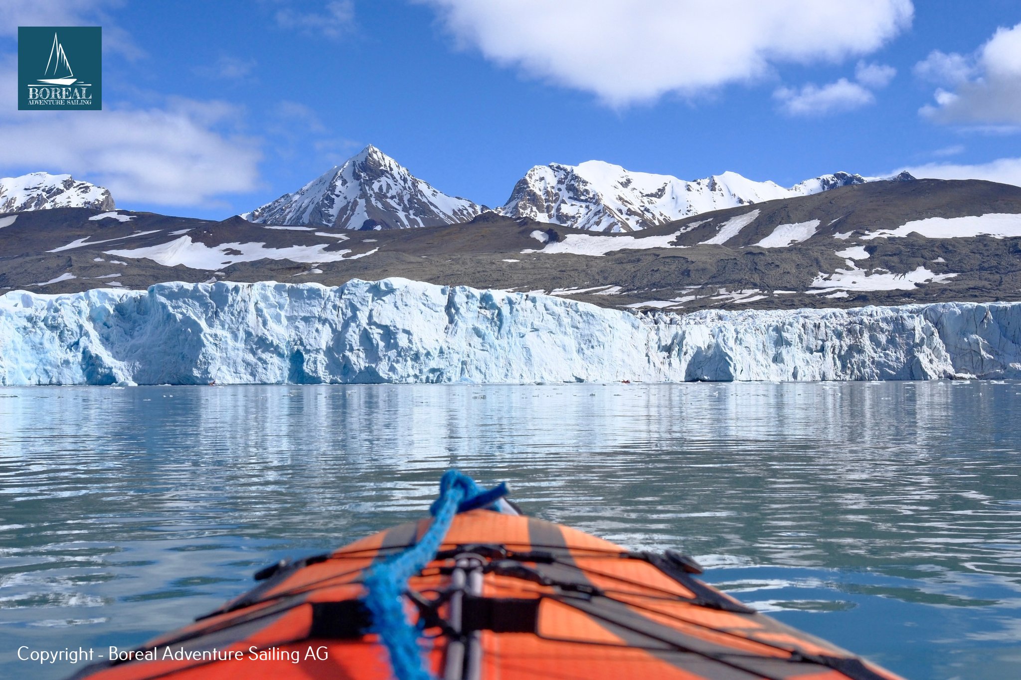Sail & Kayak, Svalbard: paddler's view from an orange kayak toward a Svalbard tidewater glacier