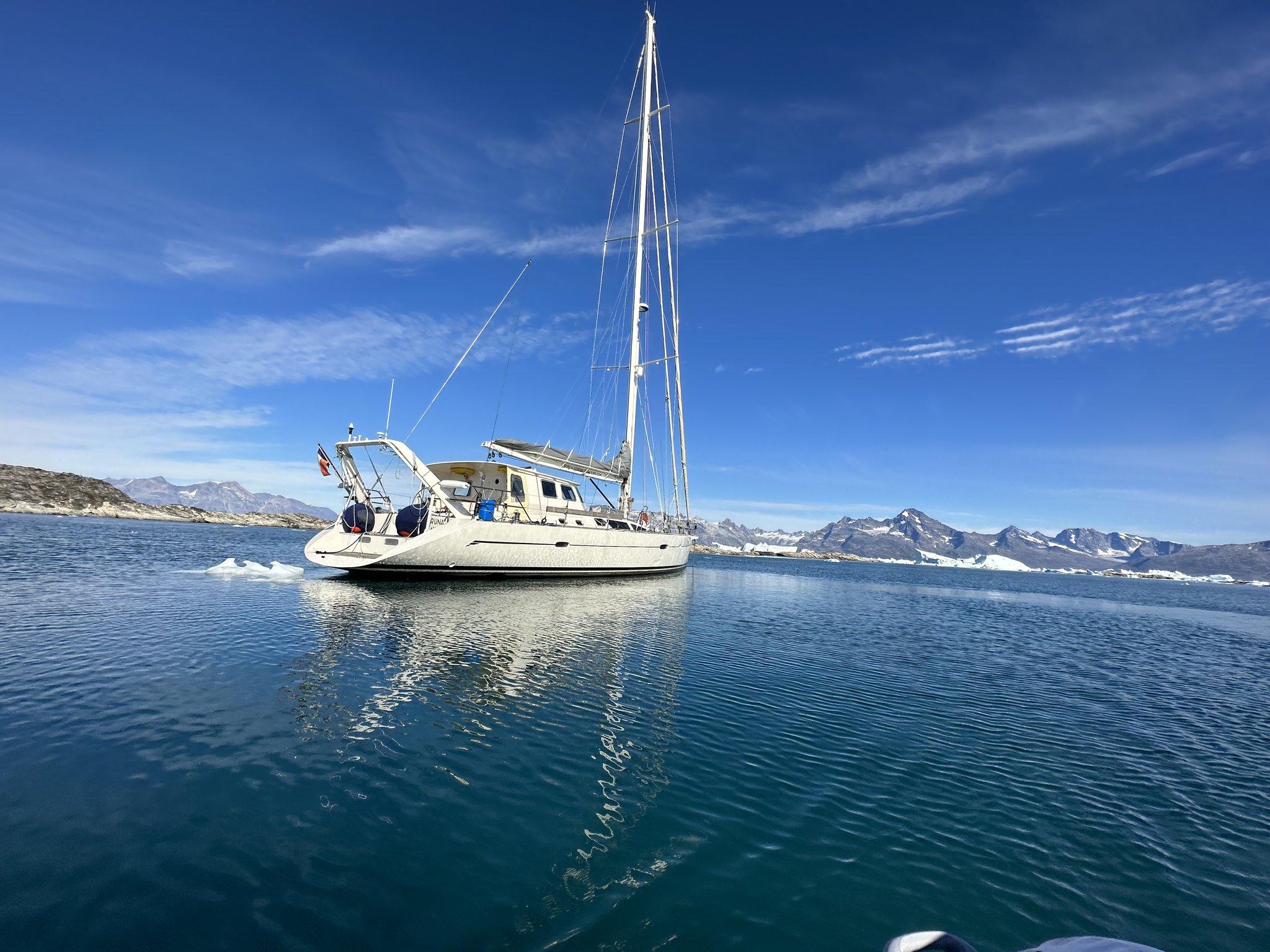 Sail & Explore, East Greenland: sailing yacht at anchor on a calm East Greenland fjord