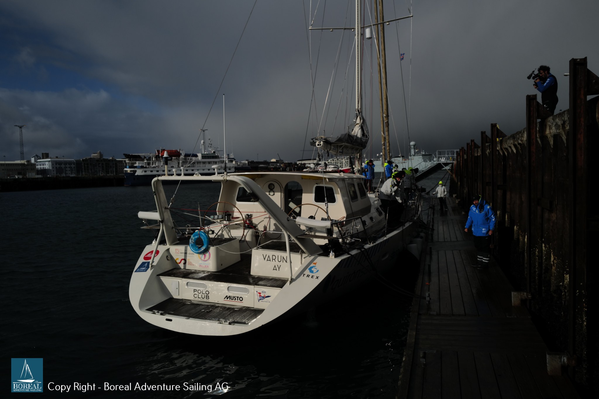 Offshore Sailing: VARUNA moored at a harbour pontoon under a stormy sky