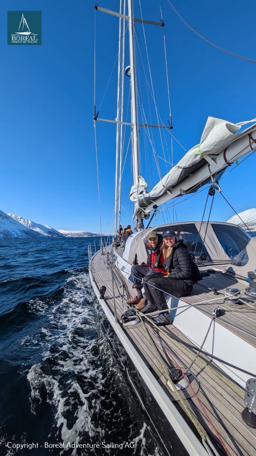 Ski & Sail, Lyngen Alps: guests on deck as the yacht heels through the fjord