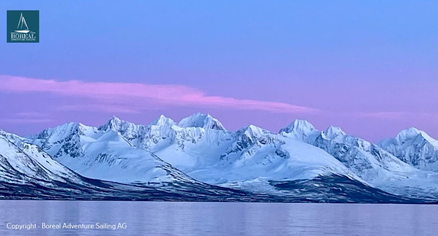 Ski & Sail, Lyngen Alps: jagged Lyngen Alps under a pink and blue twilight sky