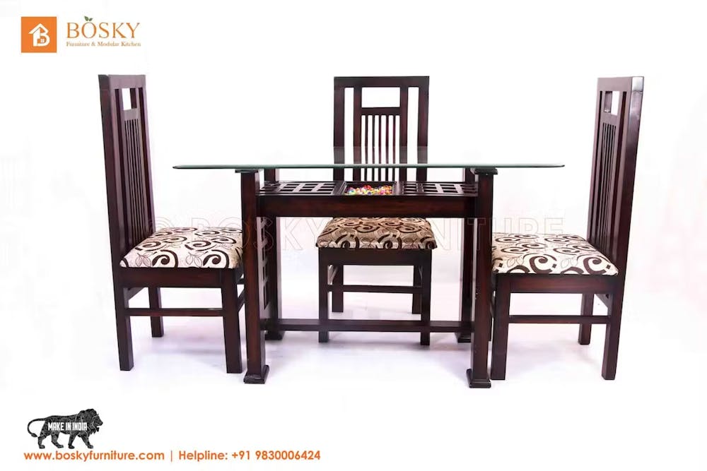 A teak wood dining table set with chairs