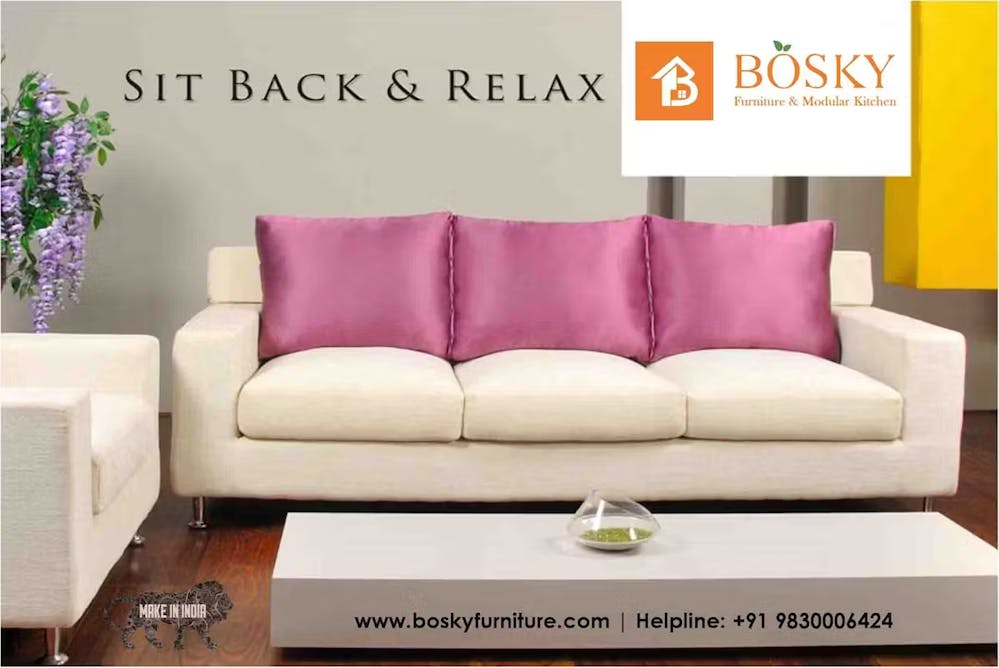A comfortable sofa with pink colored cushions