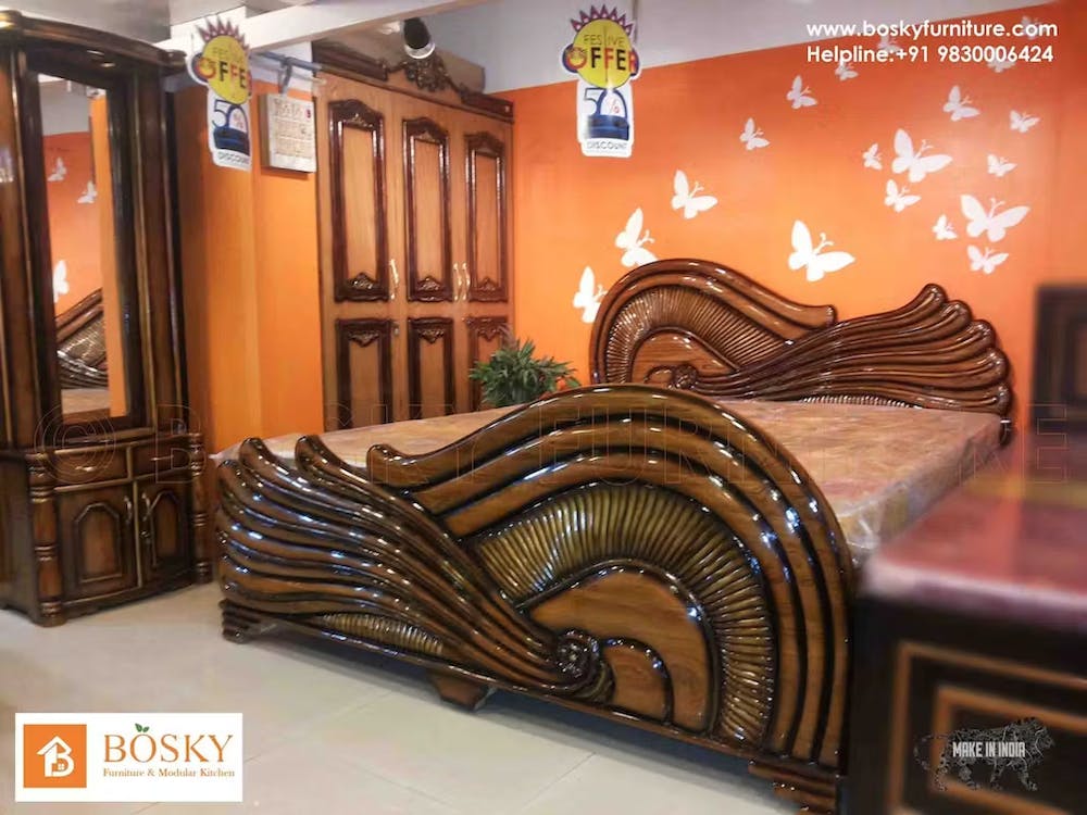A designer wooden finish bed for bedroom