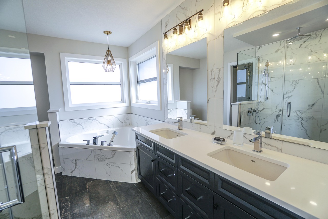 Sleek White Bathroom Design With White Countertop on Black Vanity | Bosky Interior