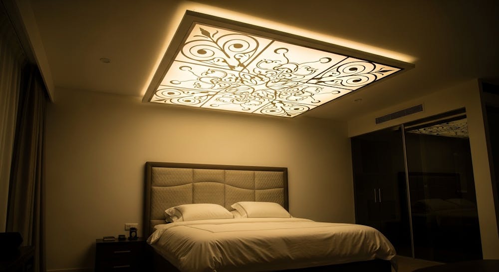 Backlit Ceiling Above the Bed