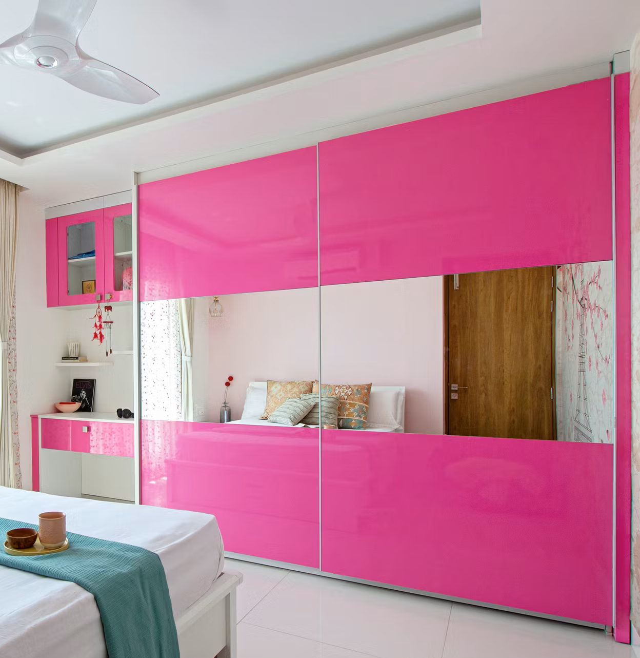 Fushia pink sliding wardrobe in a small bedroom