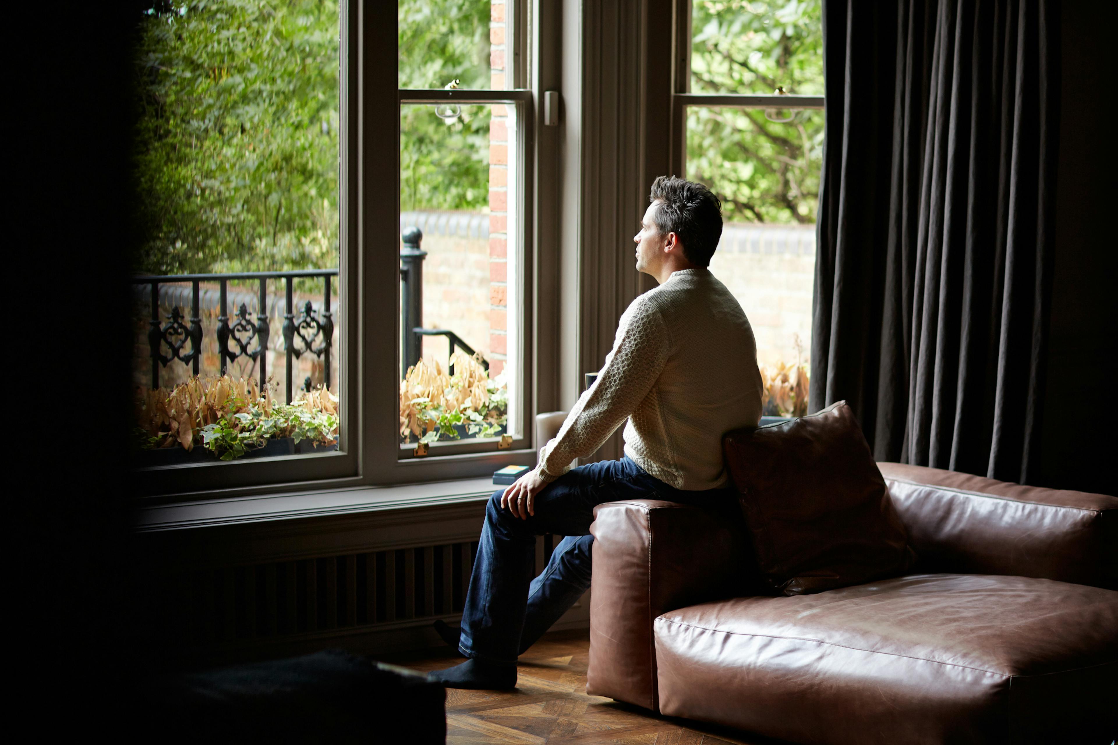 man sitting at window
