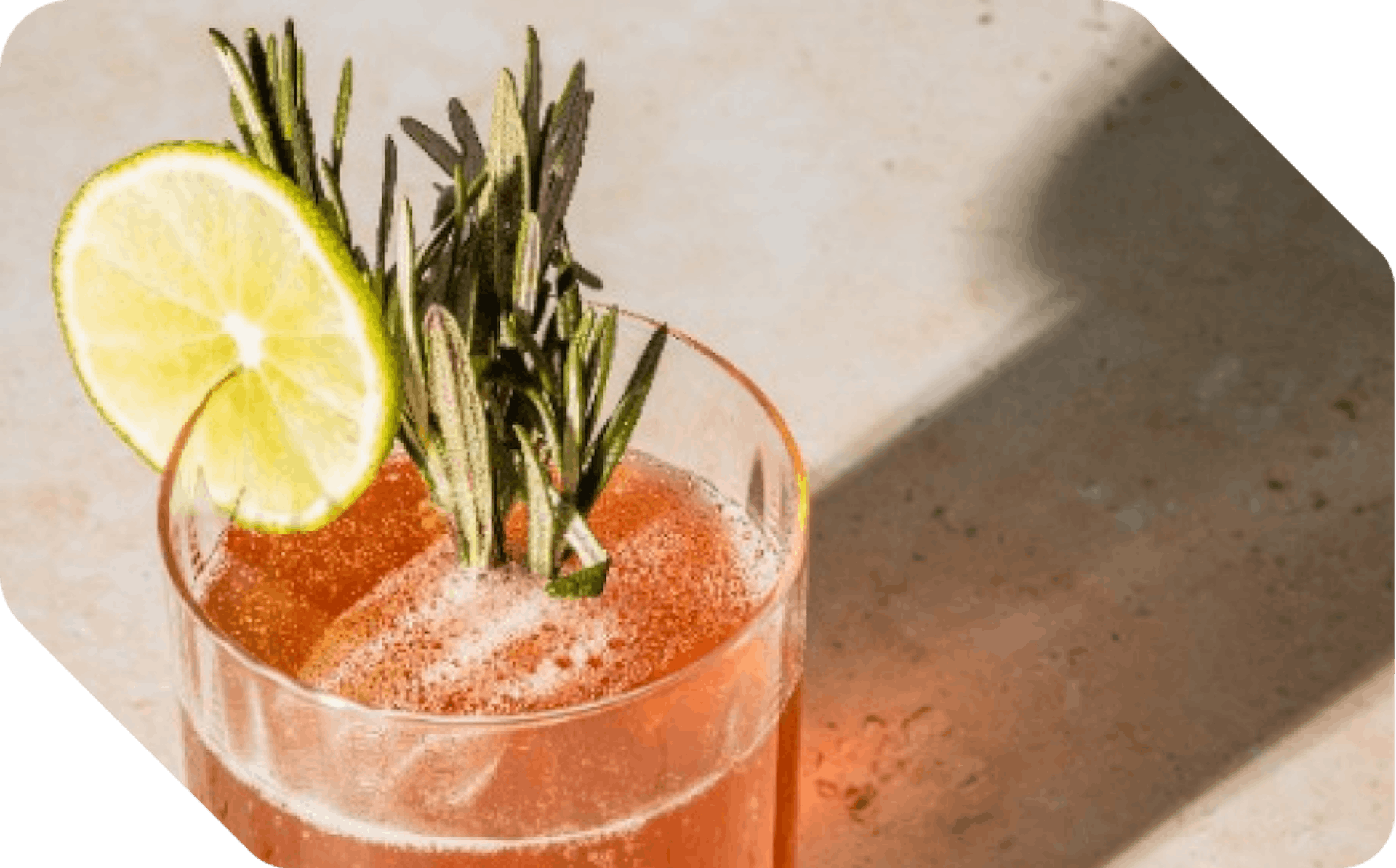 A glass of fresh juice with thyme and lime
