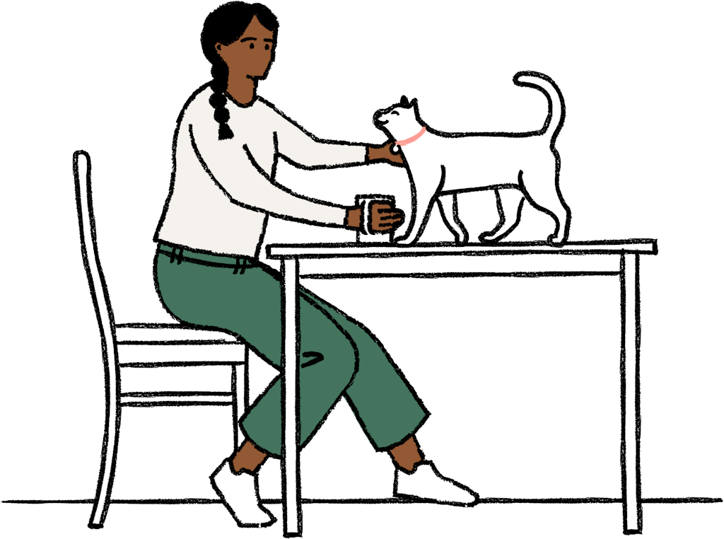 Person drinking coffee and petting a cat