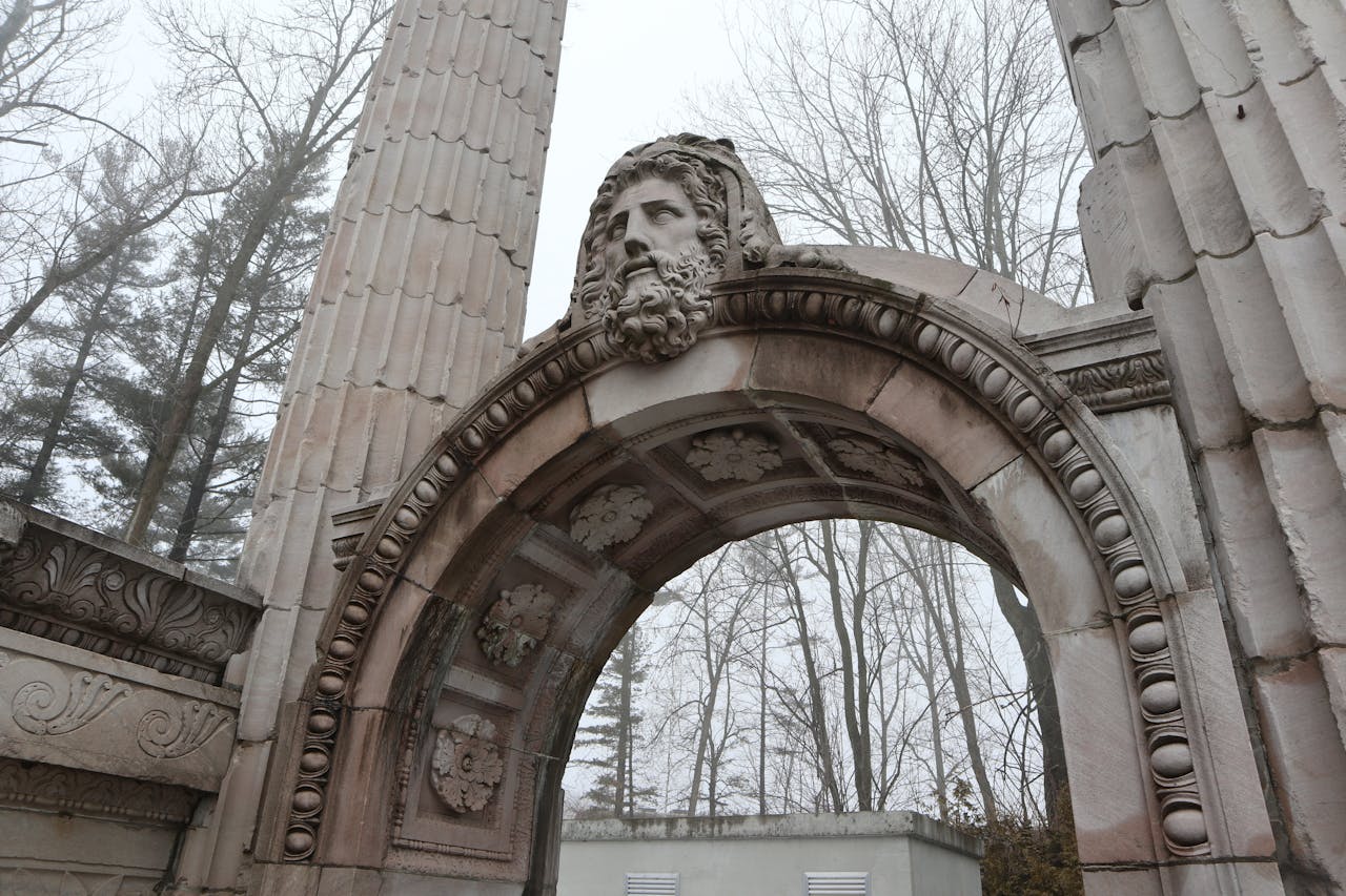 A stone monument with a carved face seen against a grey sky in Scarborough, Ontario A stone monument with a carved face seen against a grey sky in Scarborough, Ontario