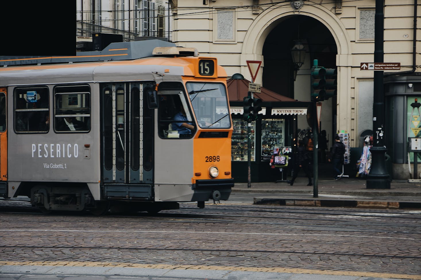 A tram stopping in a shopping district of Turin