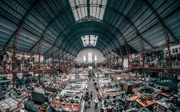 A vast indoor expo filled with visitors and trade products