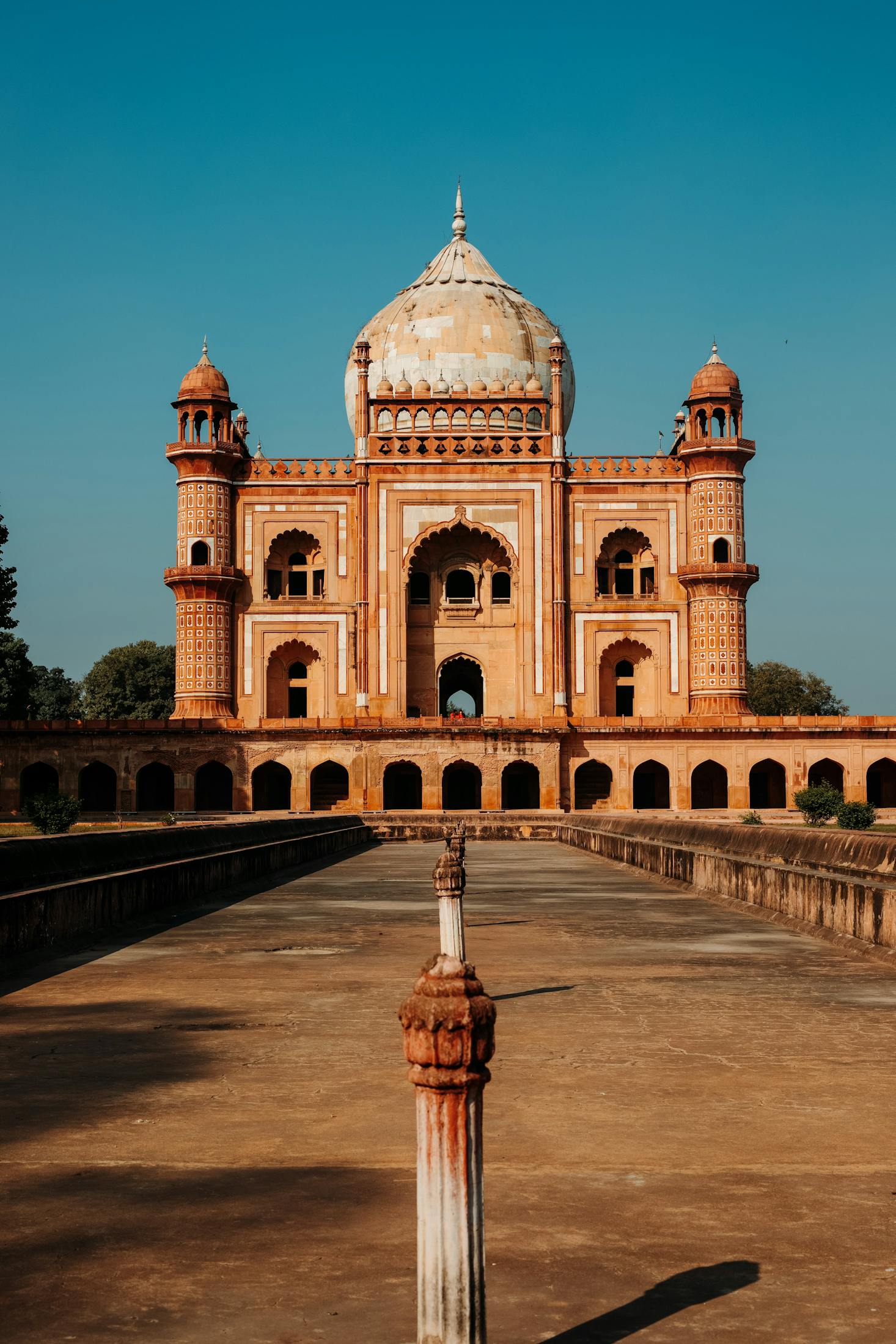 A large temple structure is framed against a blue sky in New Delhi, India