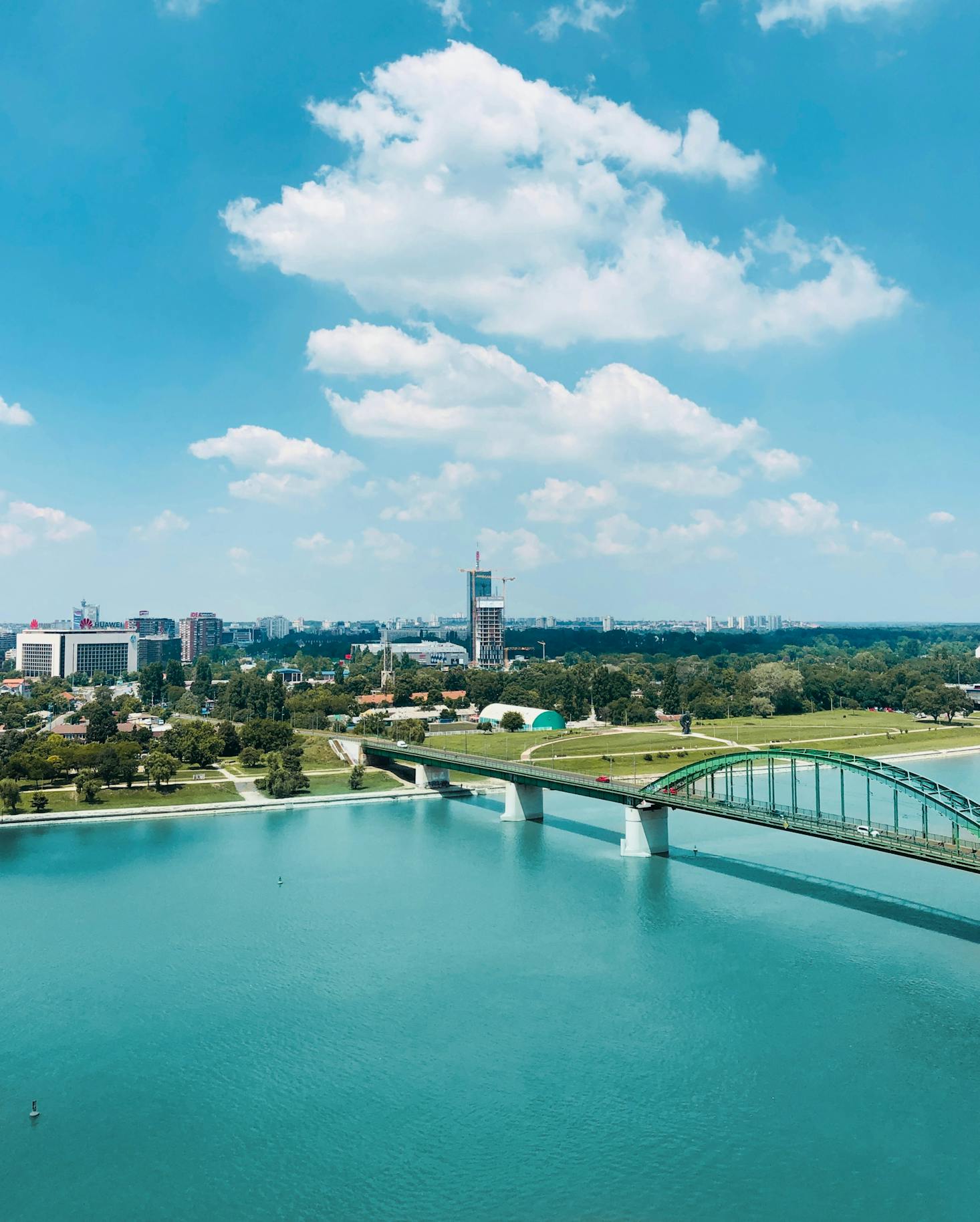 Aerial view of Belgrade with water and a bridge on a sunny day