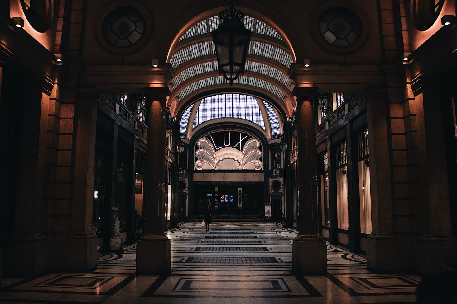 A shopping arcade in shadow in Turin