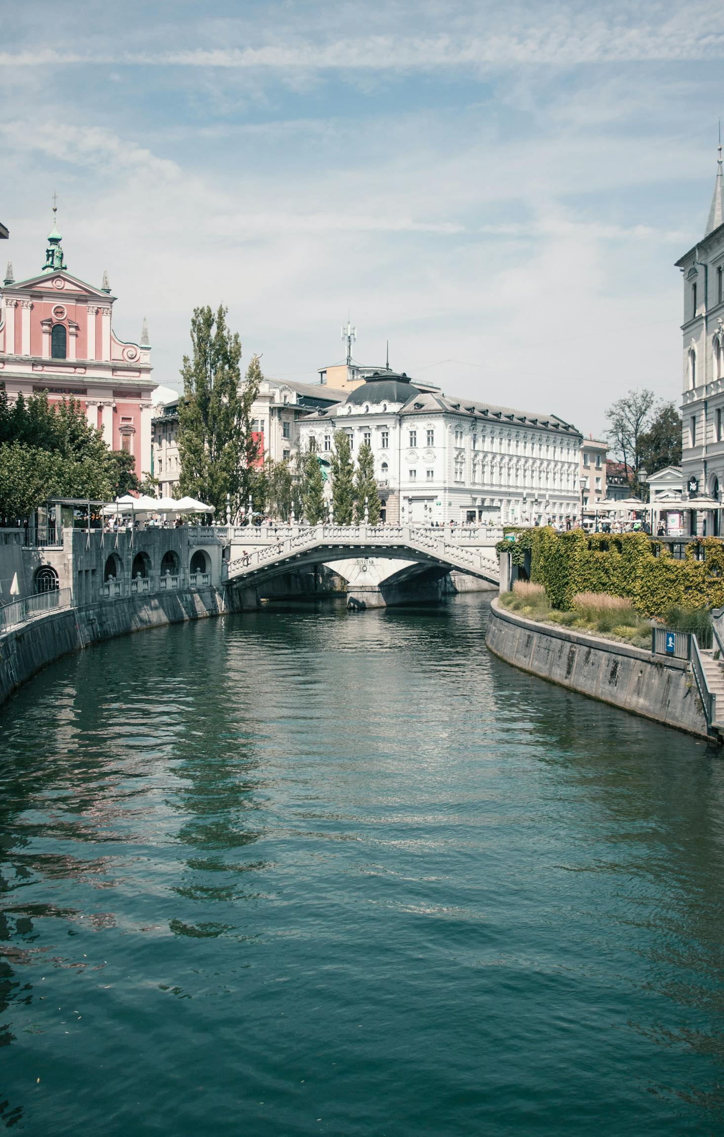 River in Ljubljana with greenery and stately buildings