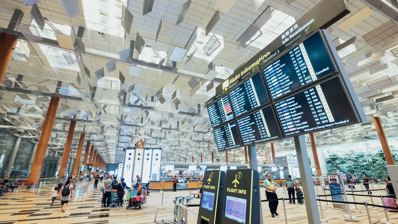 The arrival and departure boards at a modern terminal at Boston Logan Airport