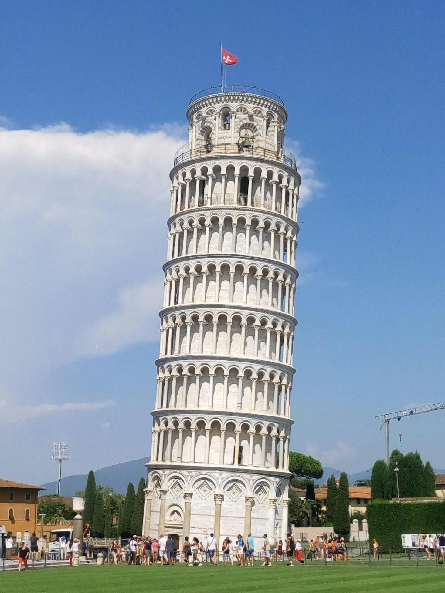 The leaning tower of Pisa near Pisa Centrale on a sunny day