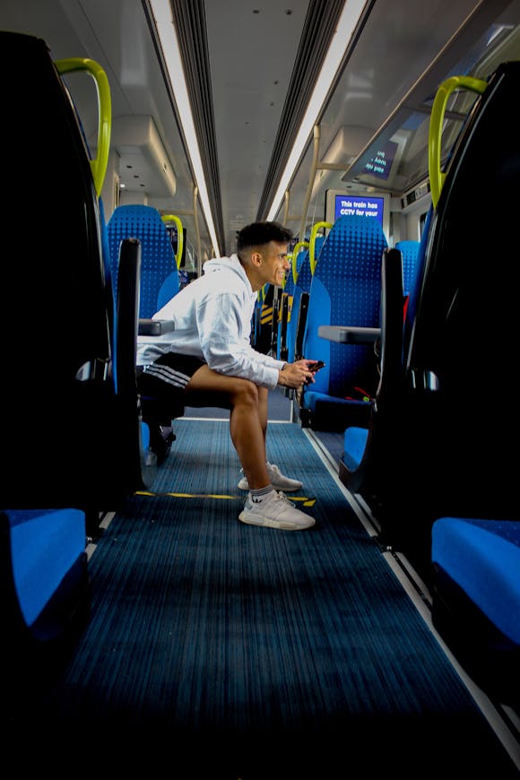 Passenger on train, Manchester Piccadilly, UK