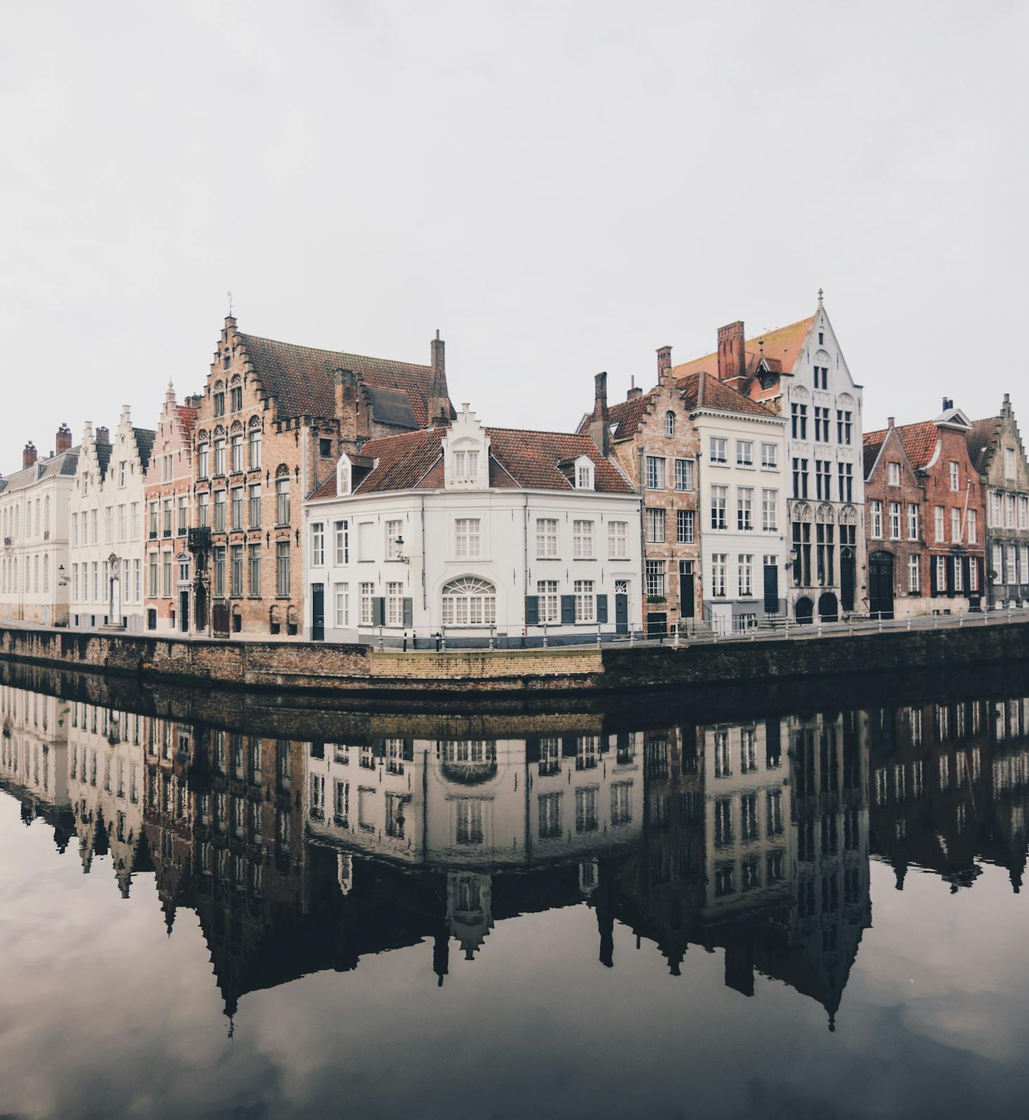 Buildings along a canal in Bruges on a gray day