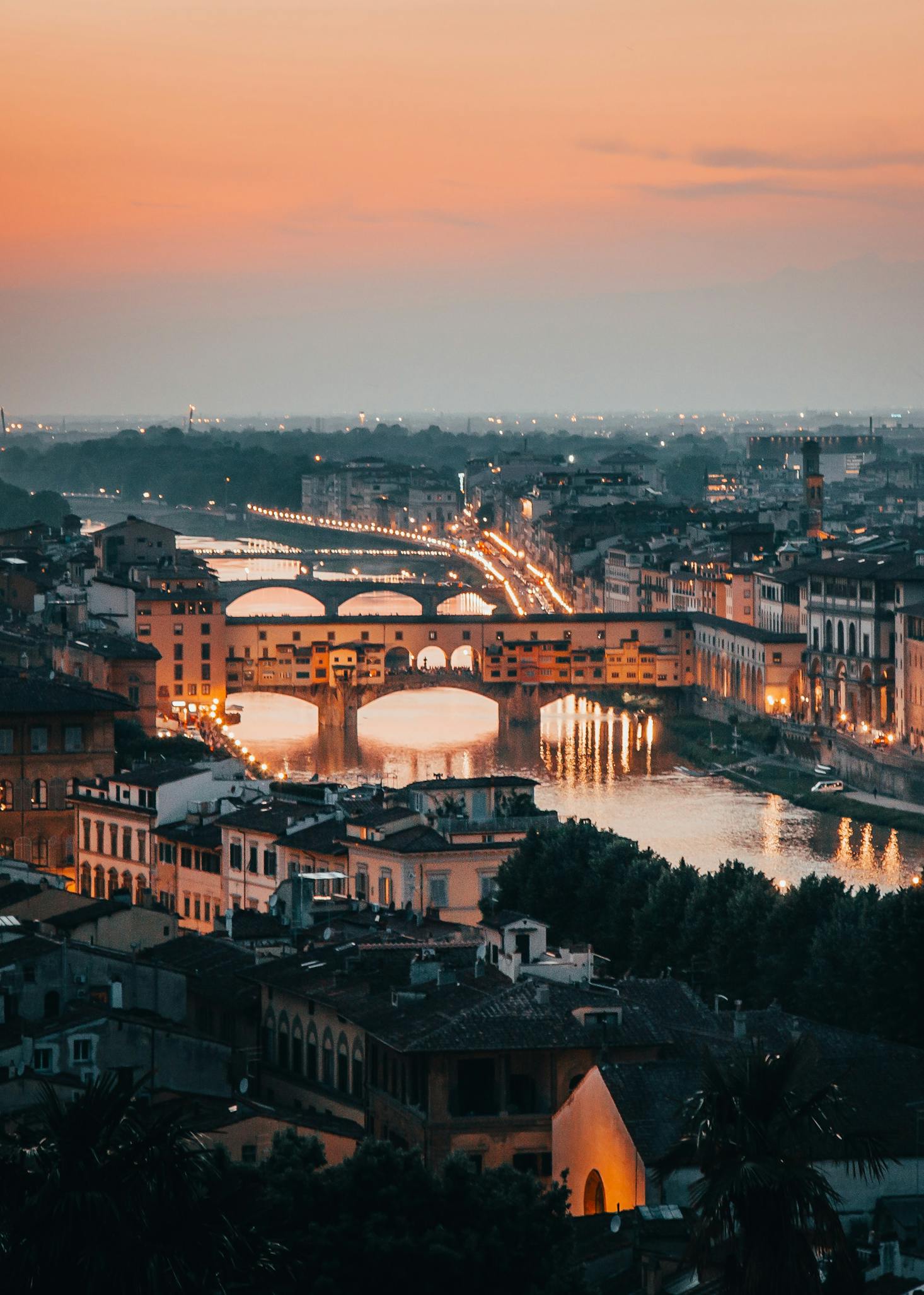 Sunset view of the Arno River in Florence with luggage storage nearby