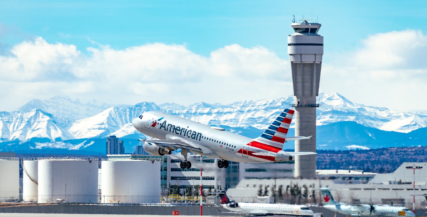 Plane taking off on a clear day at Calgary Airport in Canada