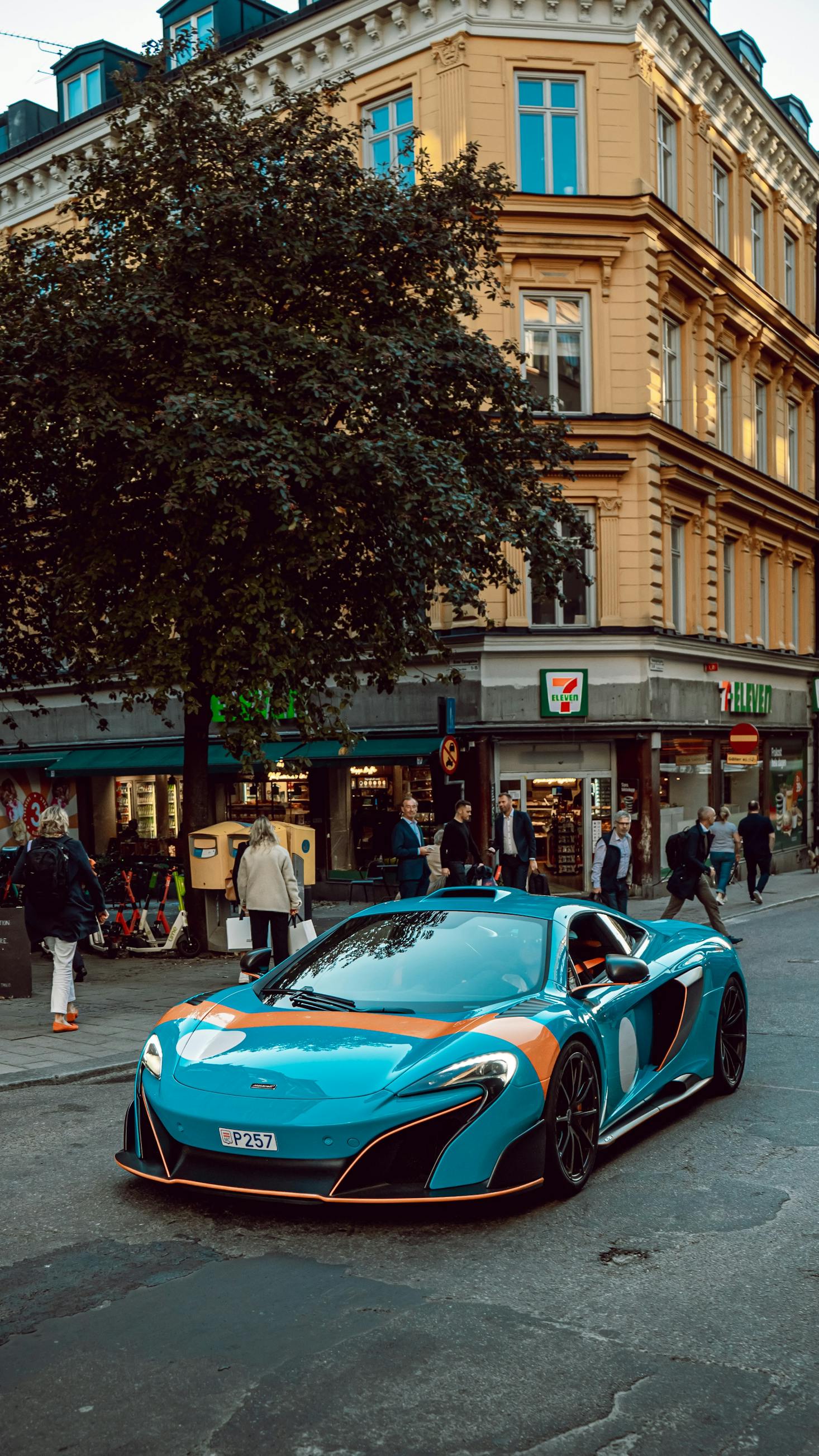 A fancy blue car parked in front of a shop in Stockholm