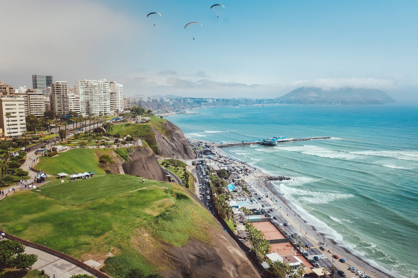 Buildings set atop a hill overlooking the ocean in Lima