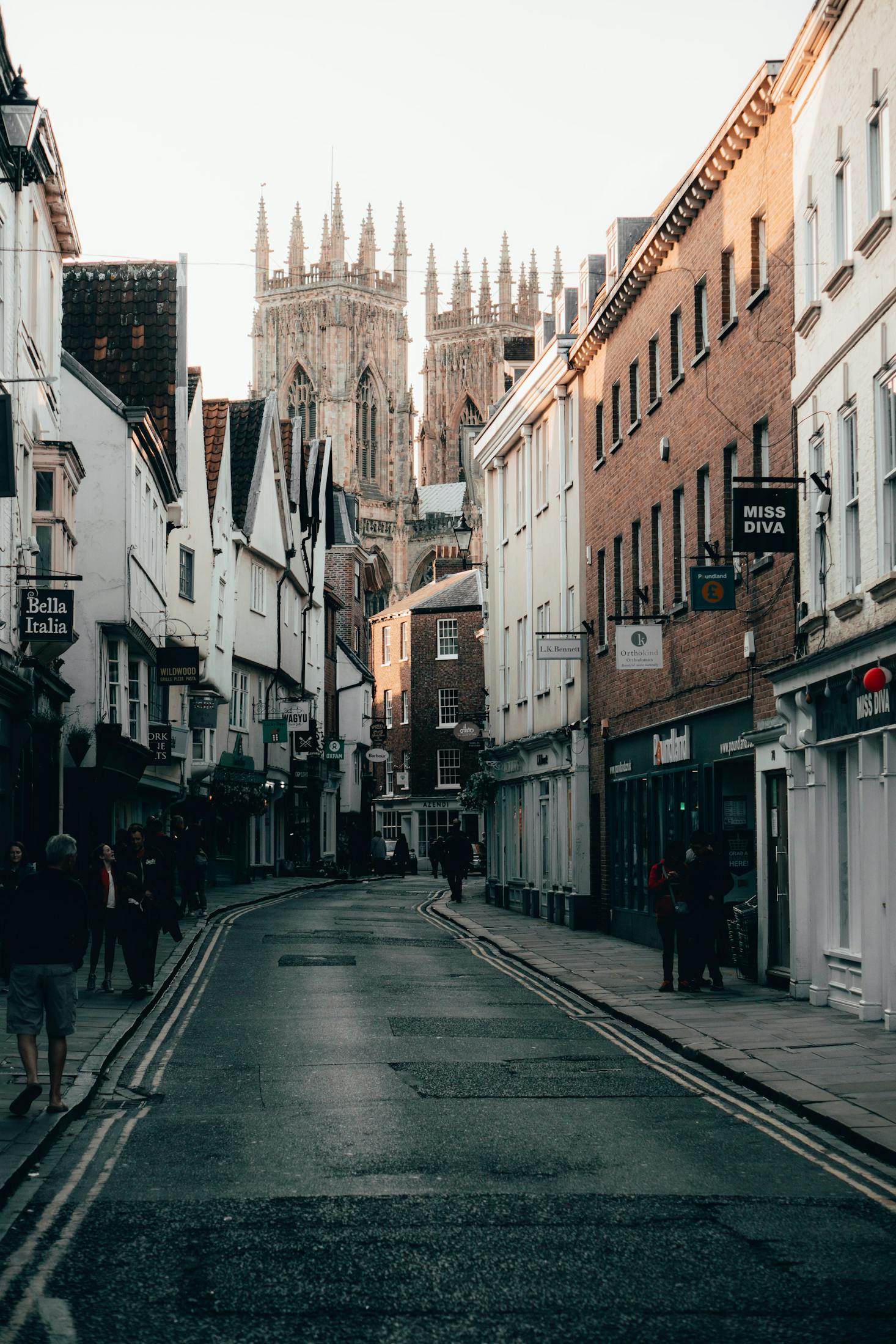 A historic street in York with the towers of York Minsters in the distance