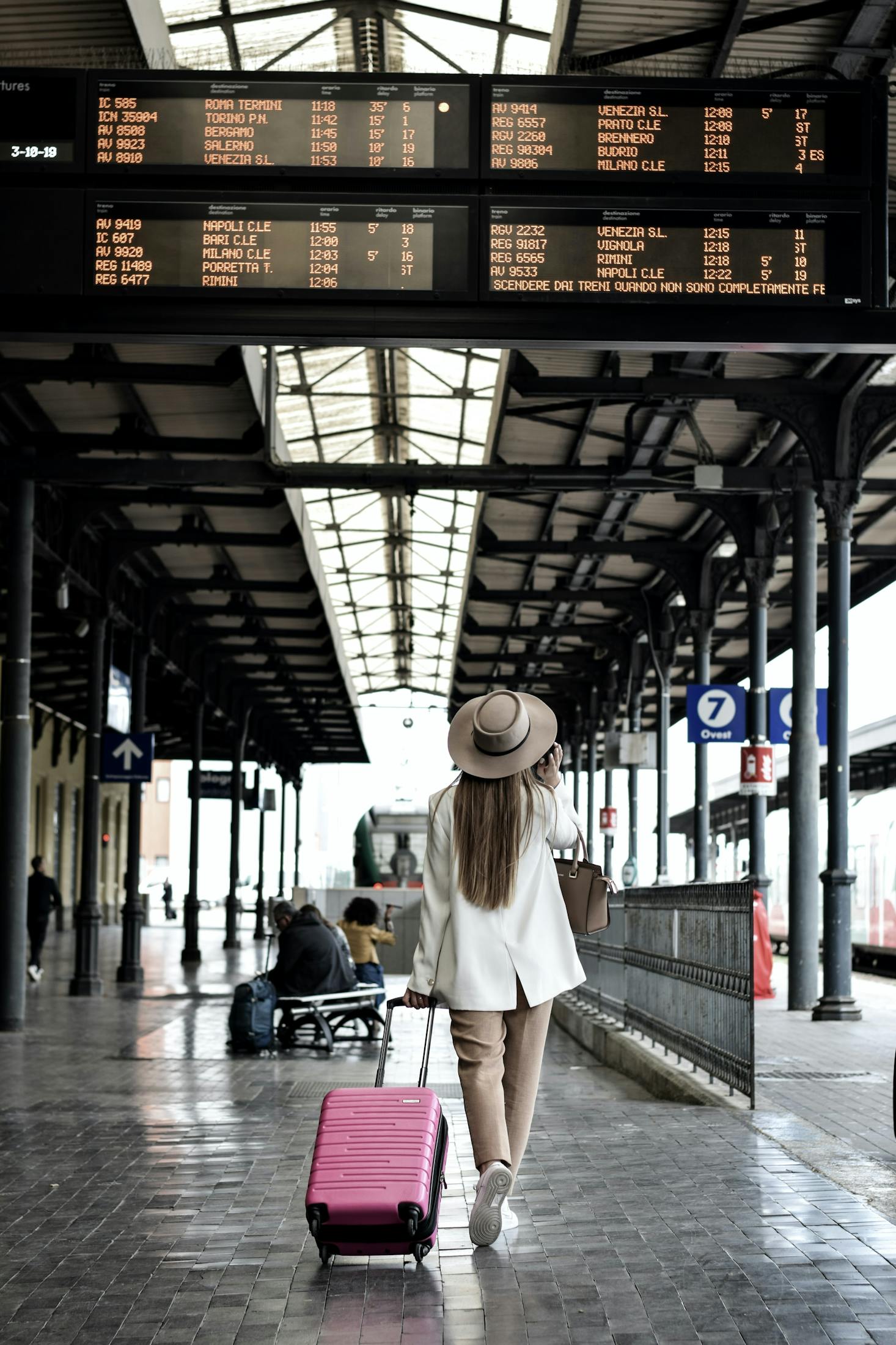 Woman carrying luggage at Bologna Centrale Train Station