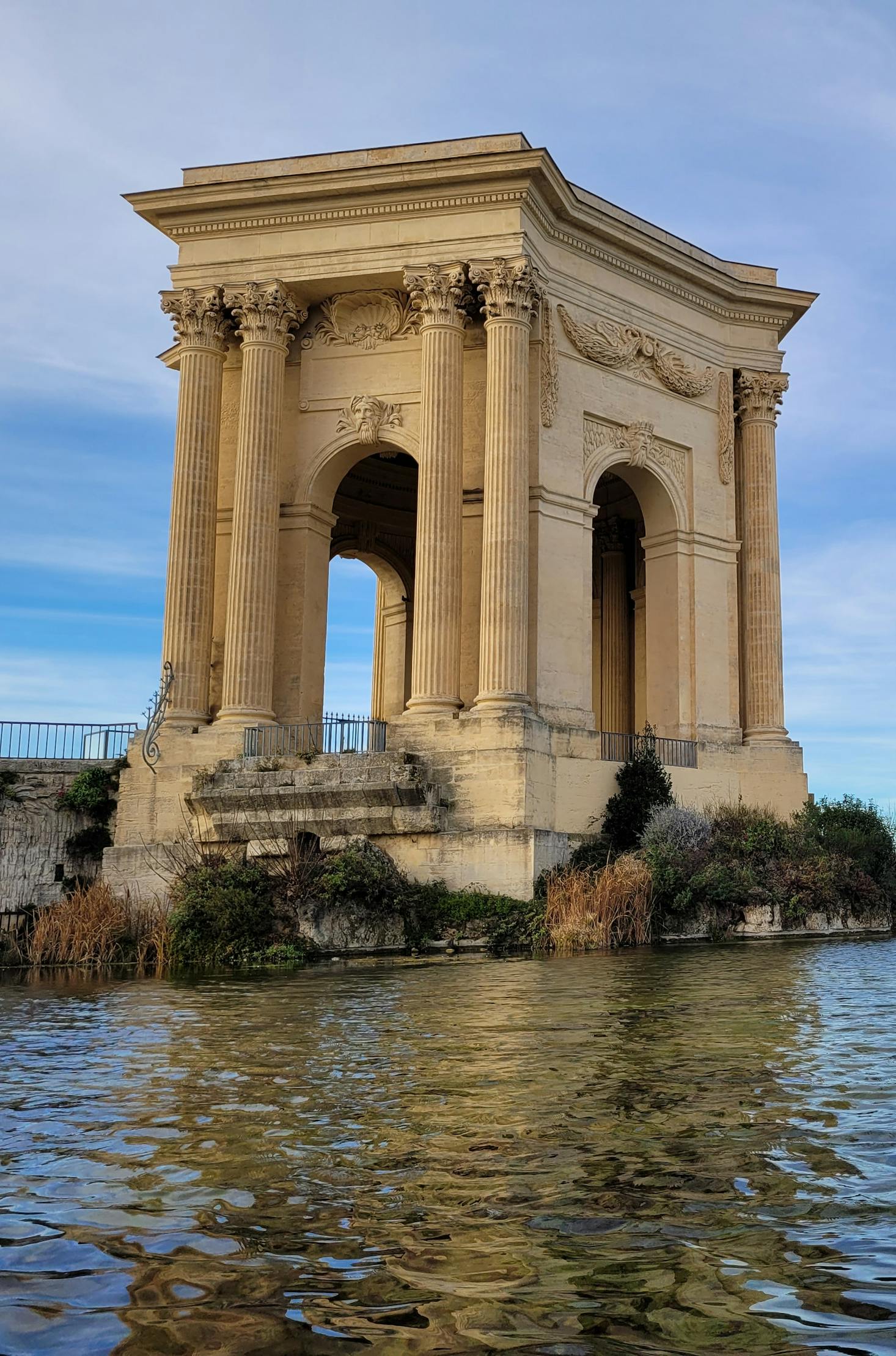 An ancient building towers over the water in Montpellier, France