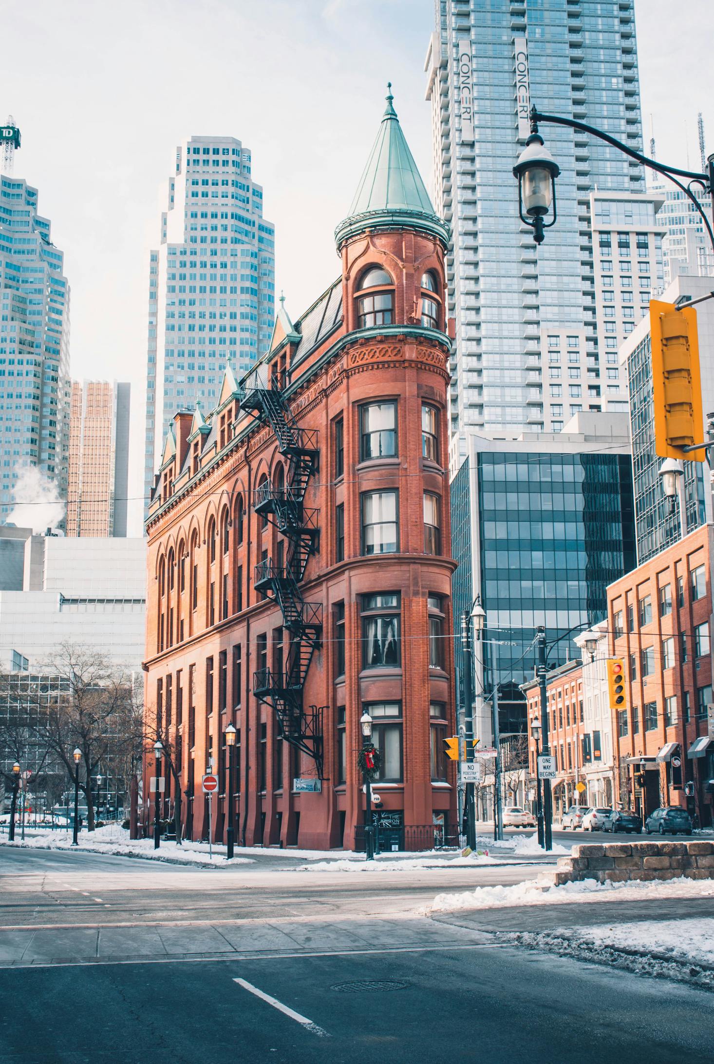 Narrow red brick building on a streetcorner in Downtown Toronto