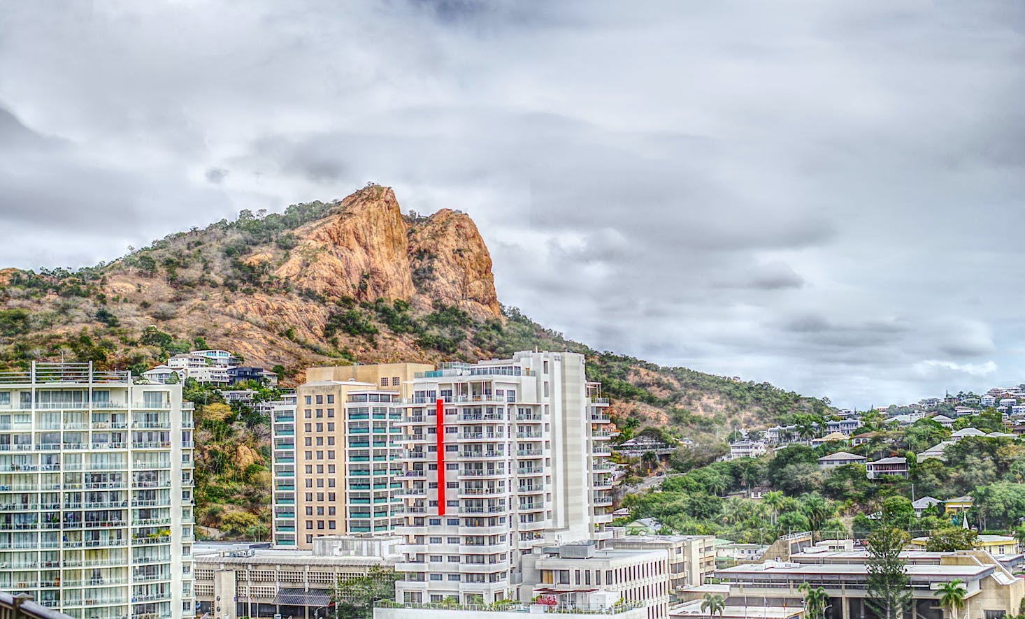 Brush-covered mountain and tall buildings in central Townsville, Australia