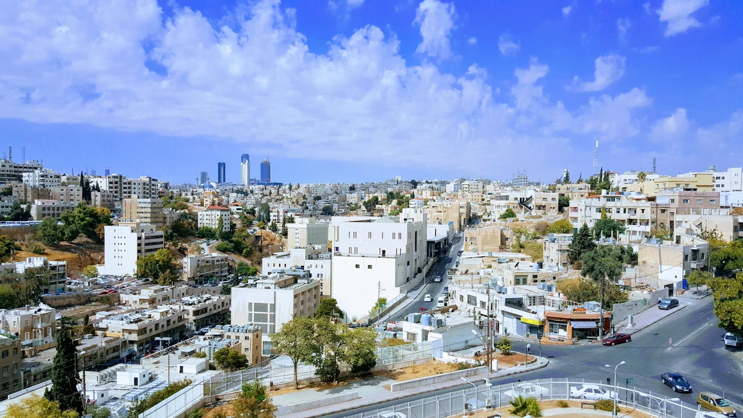 Apartment buildings in Amman, Jordan, with skyscrapers in the distance