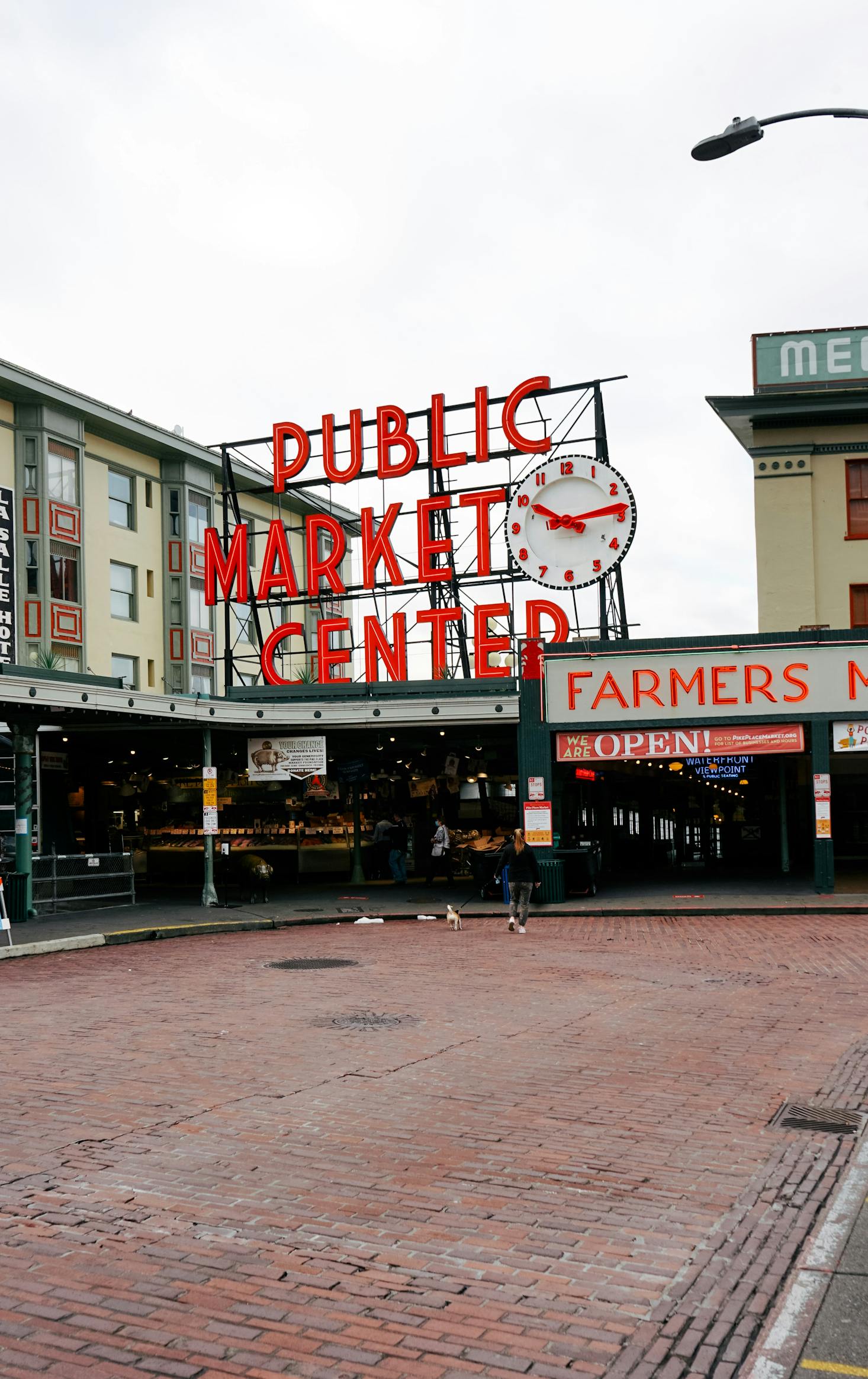 The red sign for Pike Place Market in Seattle on a cloudy day