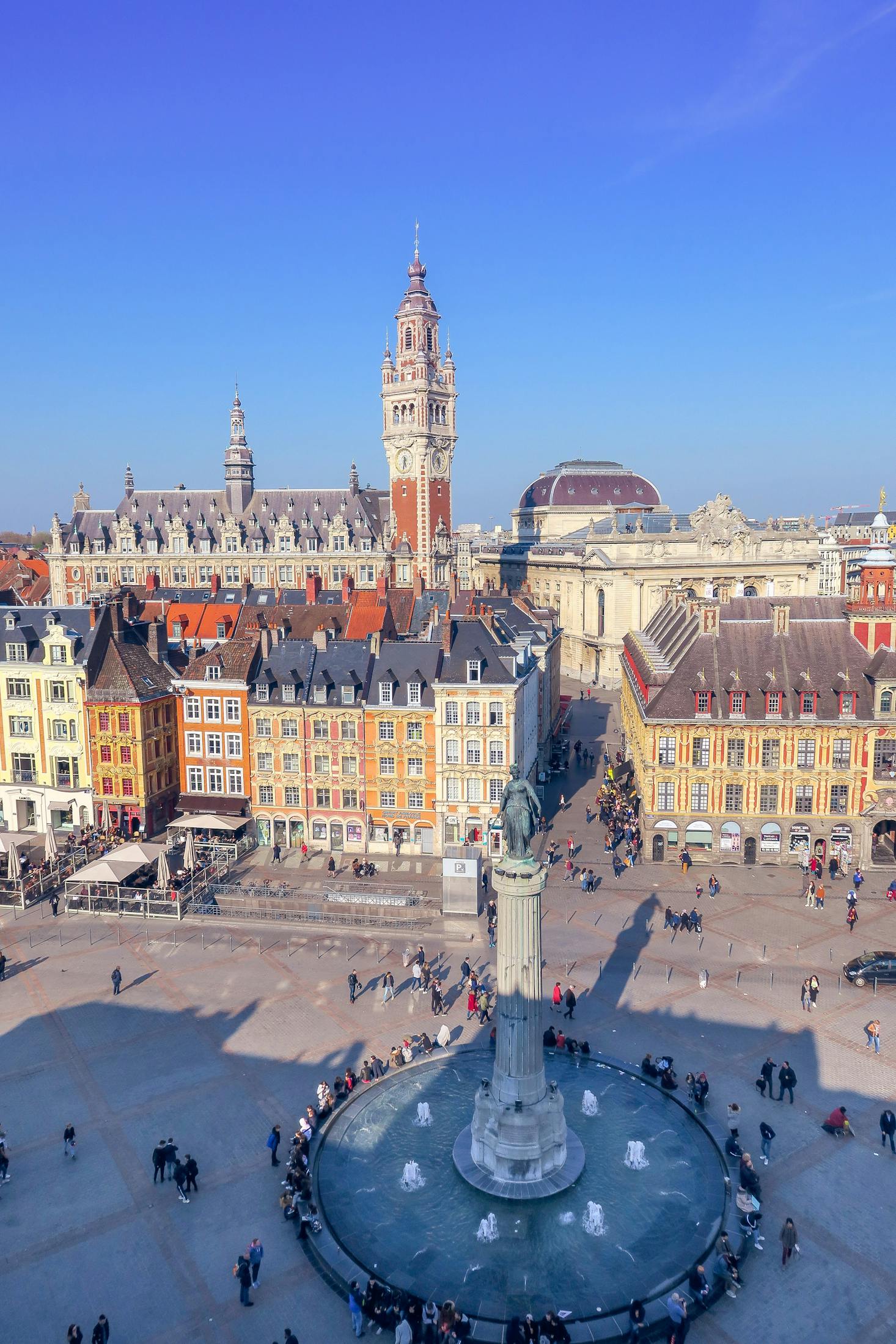 The Old Town of Lille with colorful and historic buildings and a bright blue sky