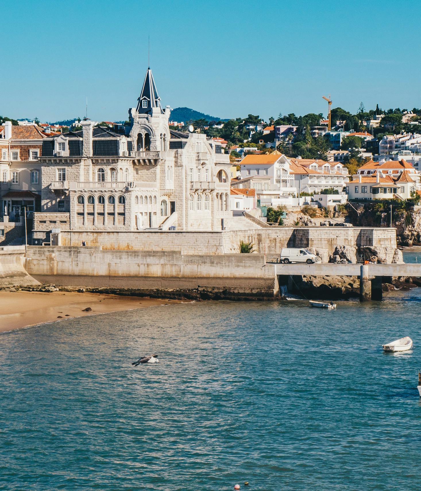 The coast in Cascais with white buildings in the background