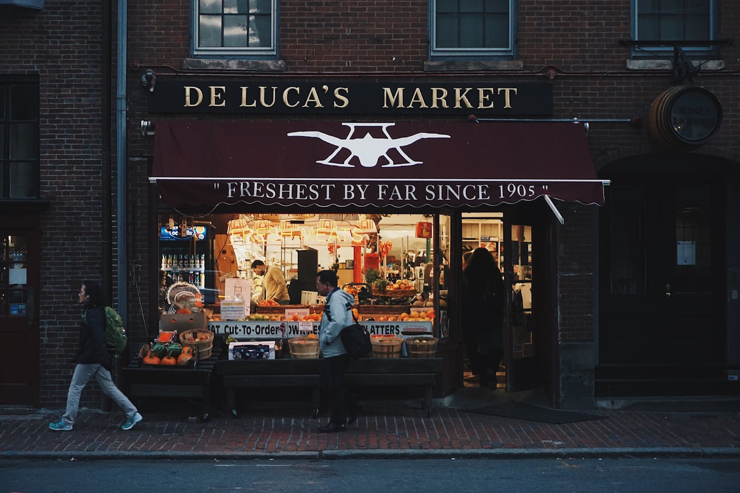 Grocery store in Boston, MA, with an American flag hanging out front