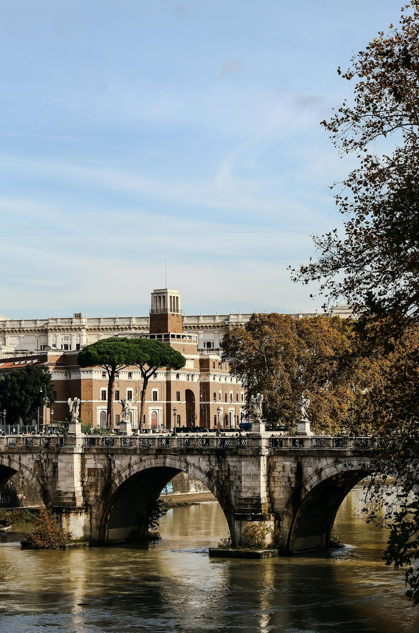 Brown building and white bridge in Trastevere, Rome