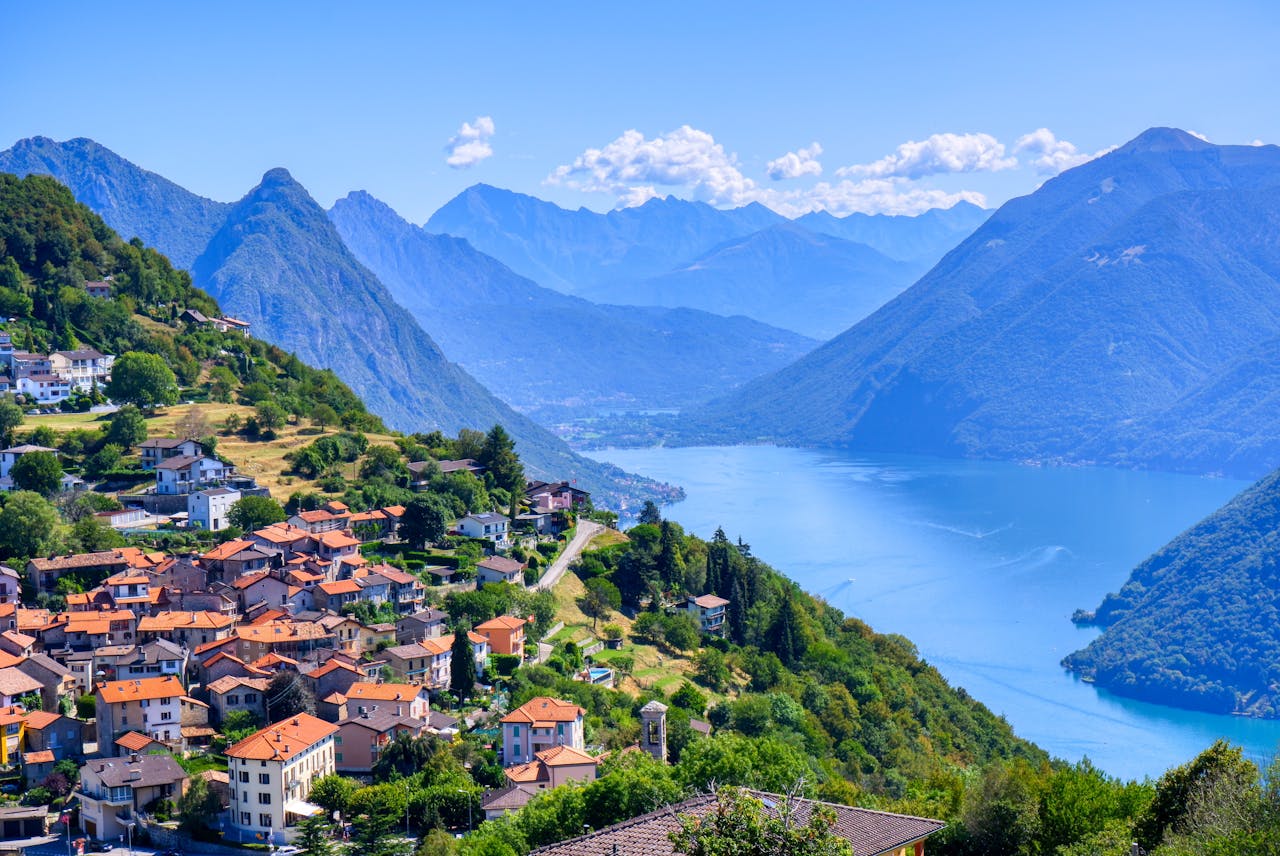 A view of mountains and water in Lugano, Switzerland A view of mountains and water in Lugano, Switzerland