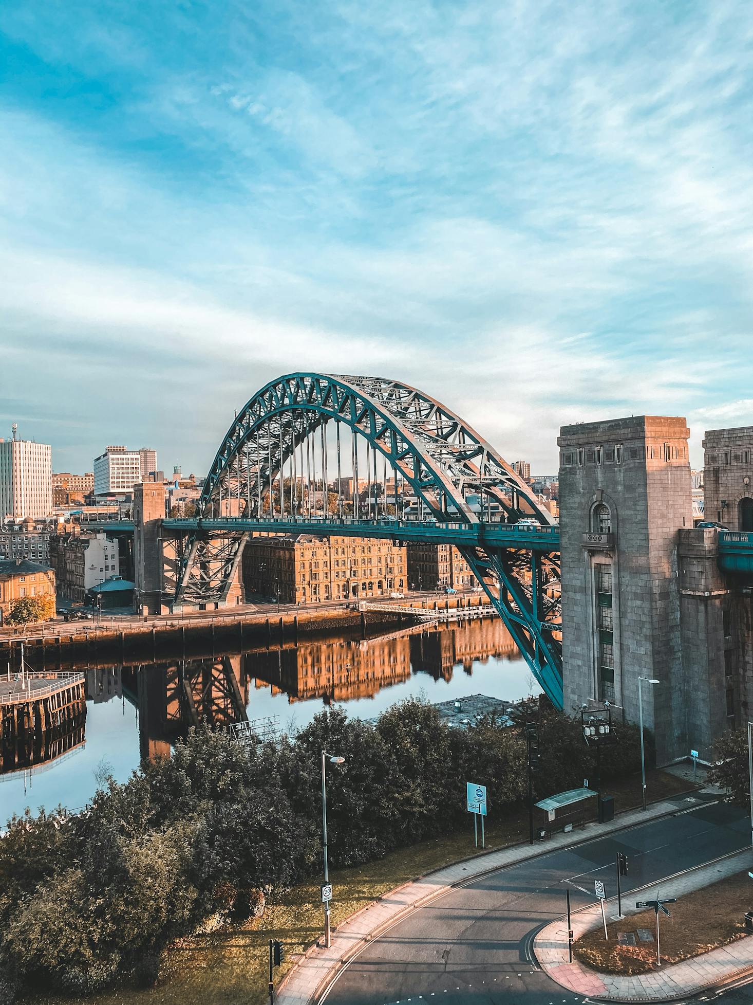 The Tyne Bridge stretches over the River Tyne amidst the city buildings in Newcastle, England