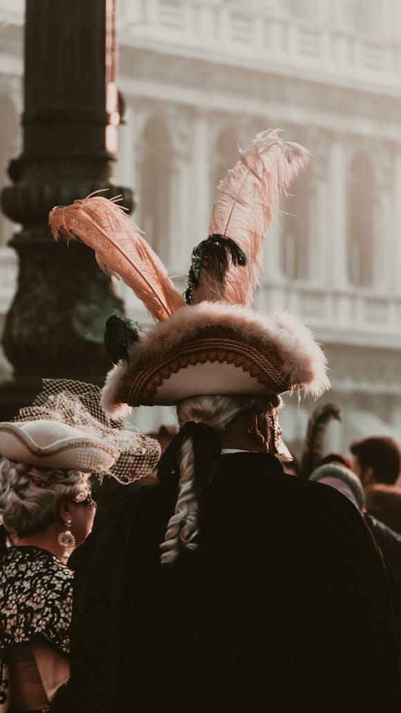 Participants wearing detailed costumes and Venetian masks, embodying the enchanting atmosphere of Venice Carnival 