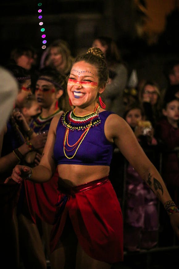 A girl wearing a costume dancing and laughing joyfully