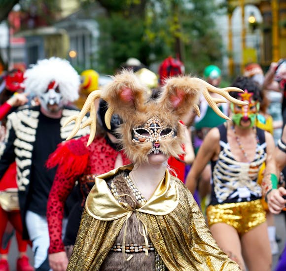 Festival goers in elaborate Renaissance costumes interacting in a lively outdoor setting