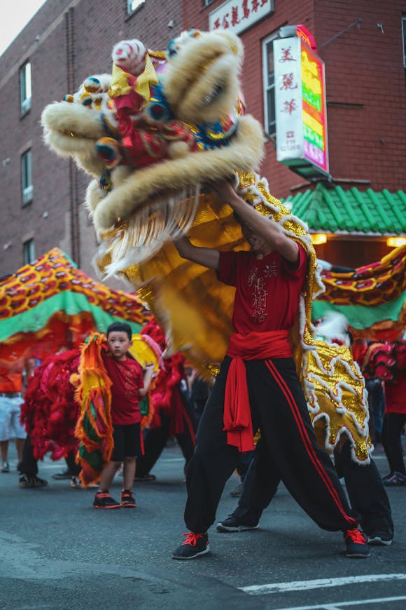 Vibrant Chinese dragon dance performers parading through the streets, celebrating the cultural festivities of the Chinese New Year Parade