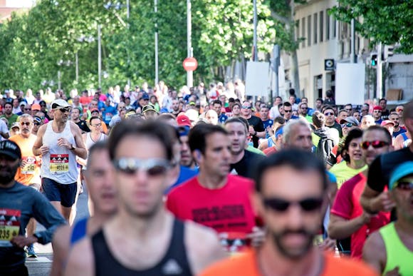 A busy street filled with vigorous marathon participants as far as the eye can see