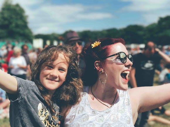 Adults and children among a crowd celebrating a festival